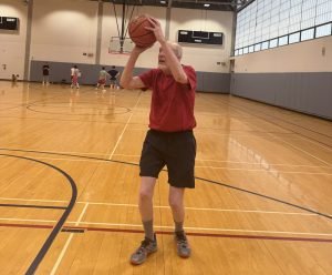 Dan Godfrey, 76, takes a shot in the Flanagan Gymnasium at Syracuse University.