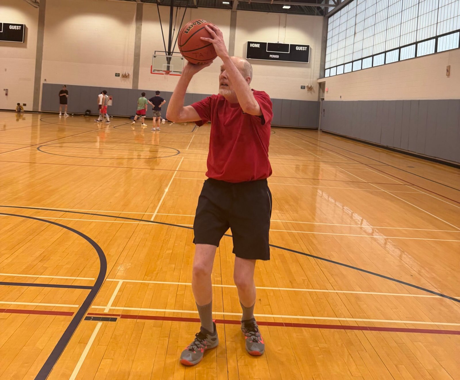 Dan Godfrey, 76, takes a shot in the Flanagan Gymnasium at Syracuse University.
