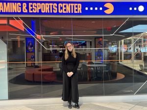 Bri Nechifor stands in front of the Gaming & Esports Center